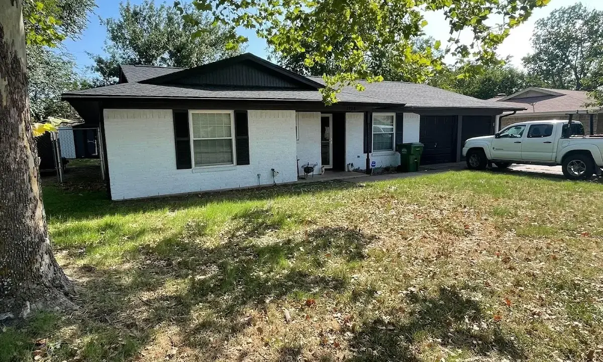 Professional roofing crew working on a residential roof in Menasha